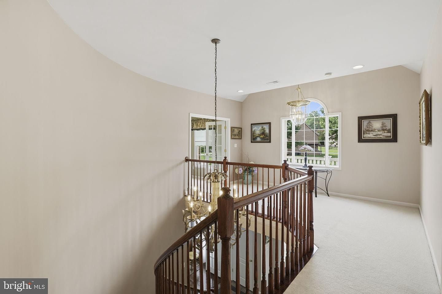 Upper hallway overlook above the curved staircase