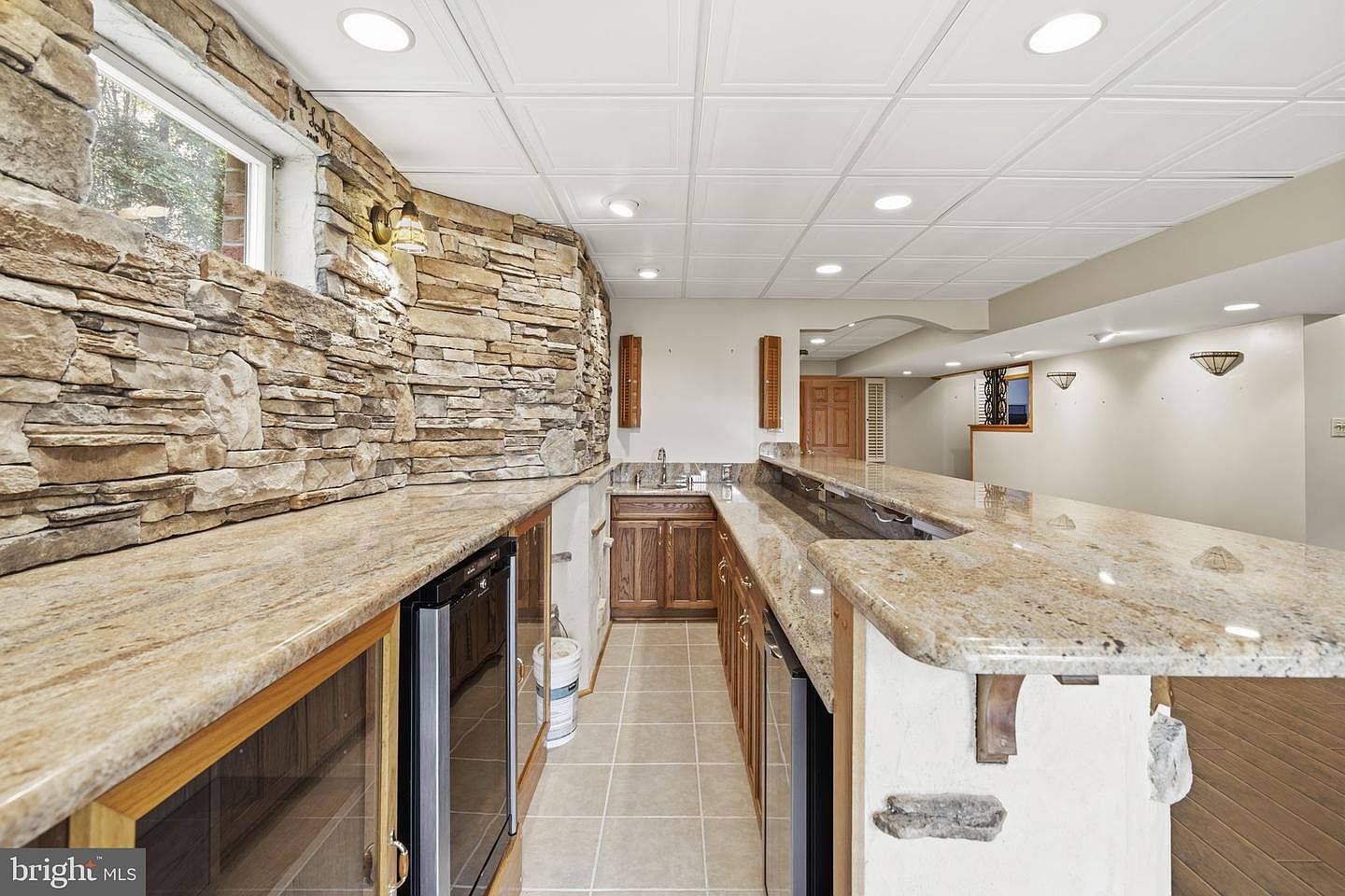 Custom wet bar with granite counters, sink and beverage fridge