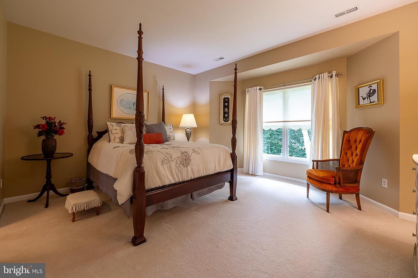 Secondary bedroom with four-poster bed and large window