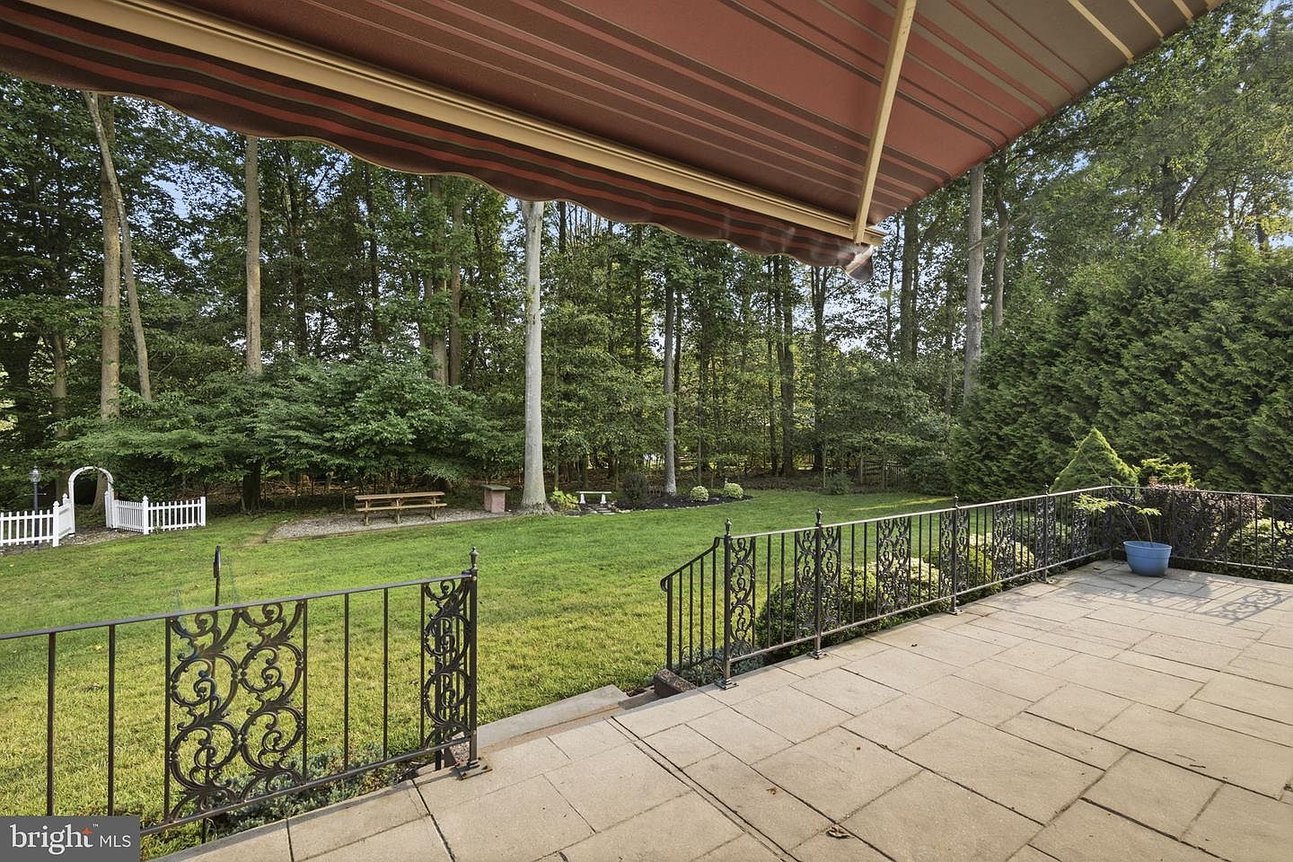 Covered patio seating area overlooking the trees