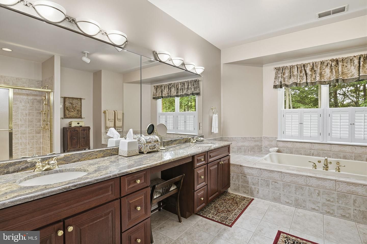 Primary bath double vanity with makeup station and wide mirror