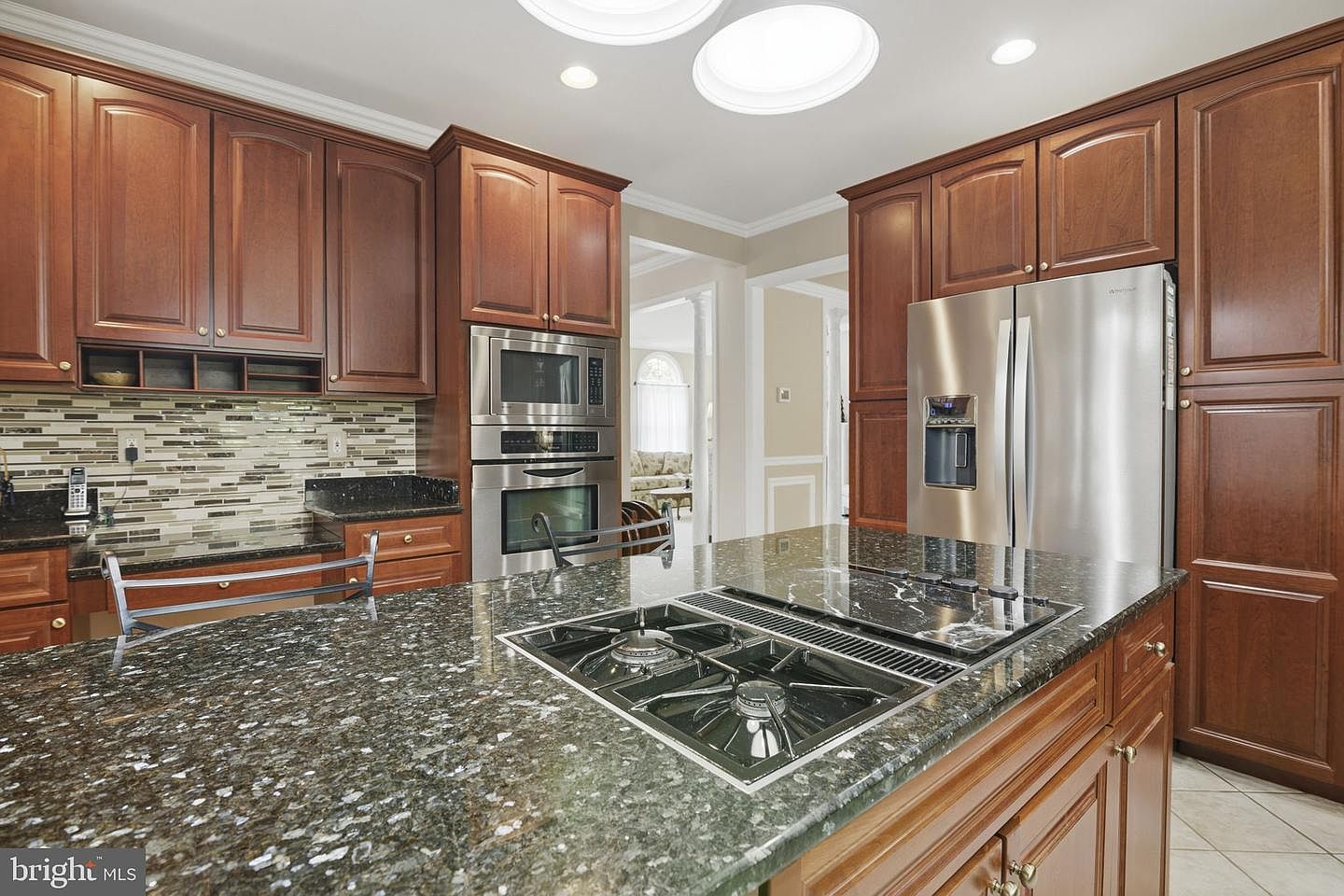 Kitchen wall ovens and gas cooktop set in granite counters
